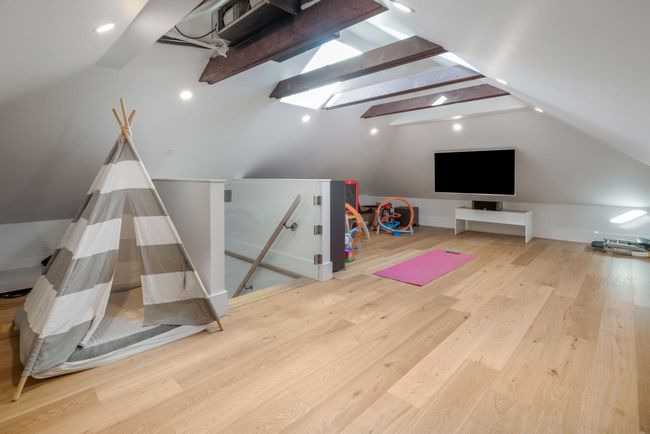 Playroom with lofted ceiling, skylight and wood floors | Image 24