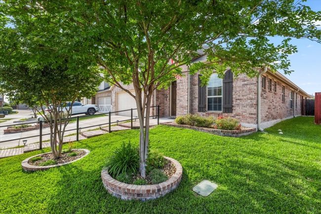 Front side yard and trees with flower beds. | Image 36