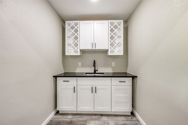 Indoor bar with wood finished floors and baseboards | Image 18