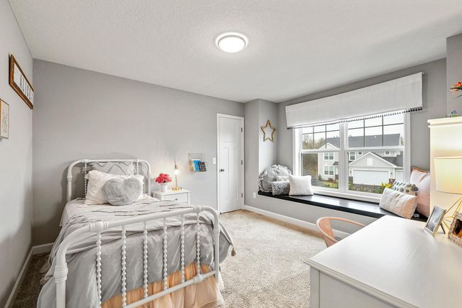 Spacious bedroom with charming built-in seating. | Image 31