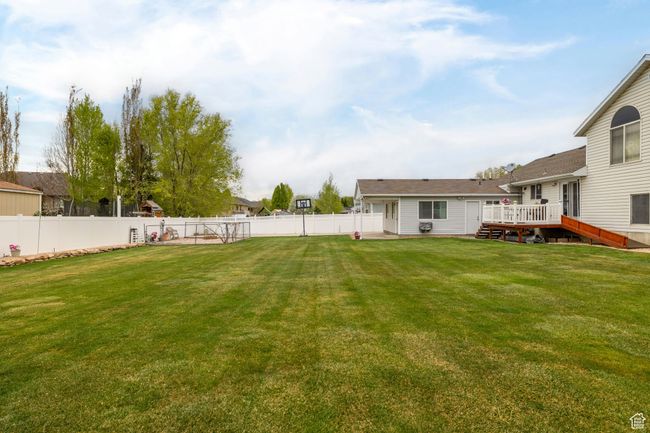 View of yard featuring a fenced backyard and a wooden deck | Image 51