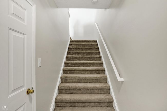 staircase with baseboards | Image 6