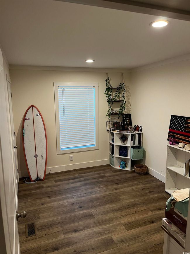 Misc room with dark wood-style floors, recessed lighting, and crown molding | Image 14