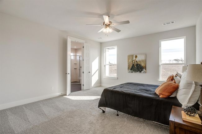Carpeted bedroom with ceiling fan and multiple windows | Image 21
