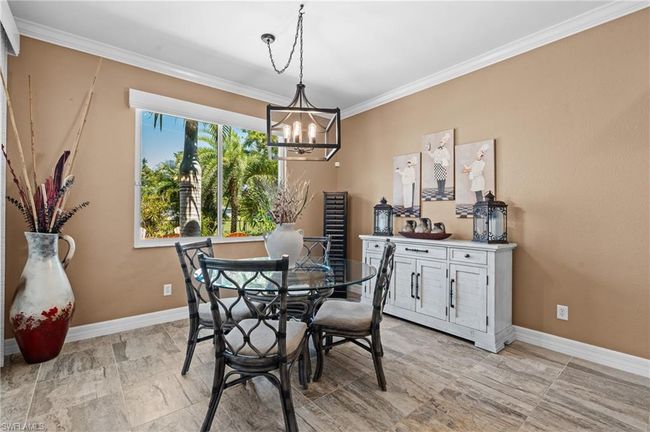 Dining room featuring a chandelier, ornamental molding, and baseboards | Image 23