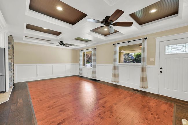 Foyer entrance featuring crown molding, a ceiling fan, and coffered ceiling | Image 5