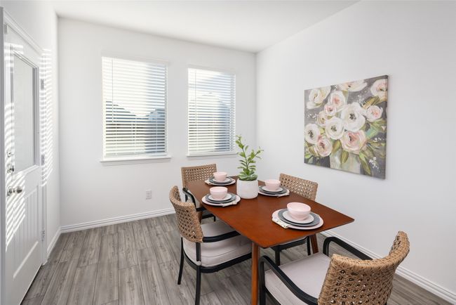 Dining space featuring wood finished floors and baseboards | Image 10