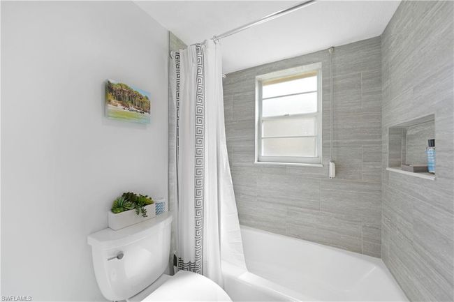 Bathroom with shower / tub combo with curtain and toilet | Image 31