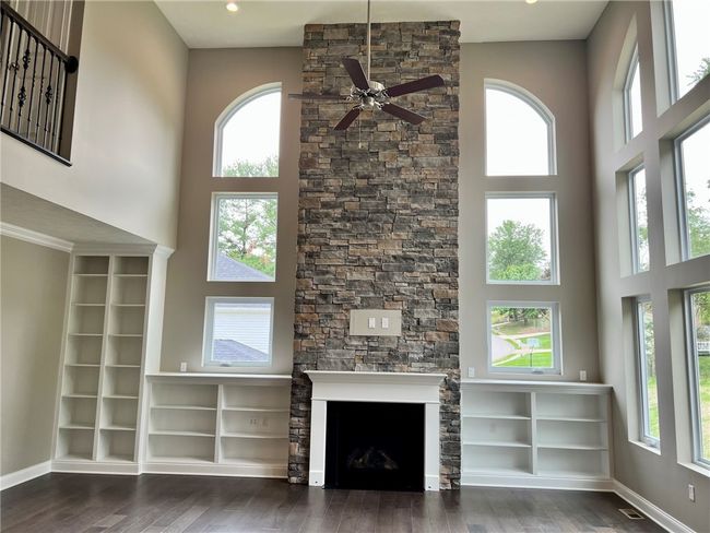 Built in book shelves to highlight the impressive fireplace windows | Image 7