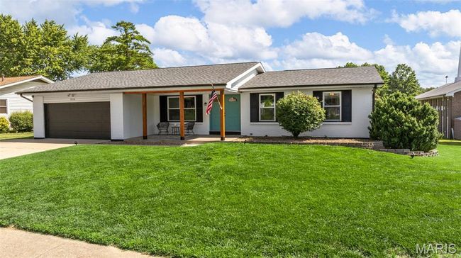 Single story home featuring covered porch, a garage, a front yard, concrete driveway, and brick siding | Image 36