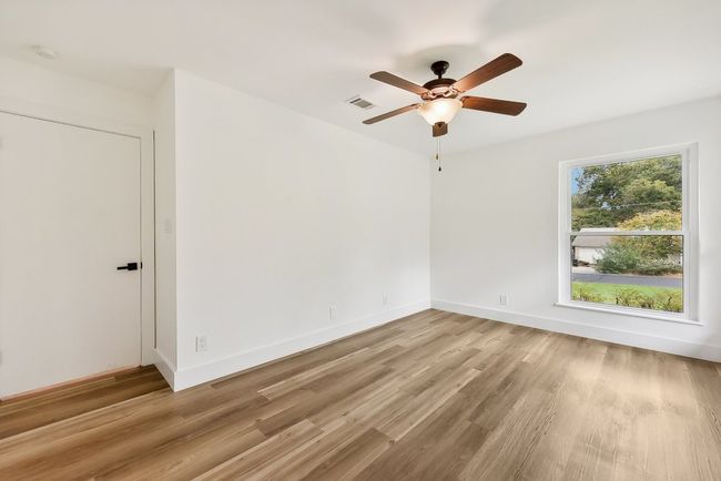 Empty room featuring visible vents, baseboards, light wood-type flooring, and a ceiling fan | Image 17