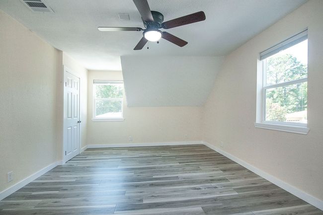 2nd floor room with ceiling fan and wood finished floors | Image 22