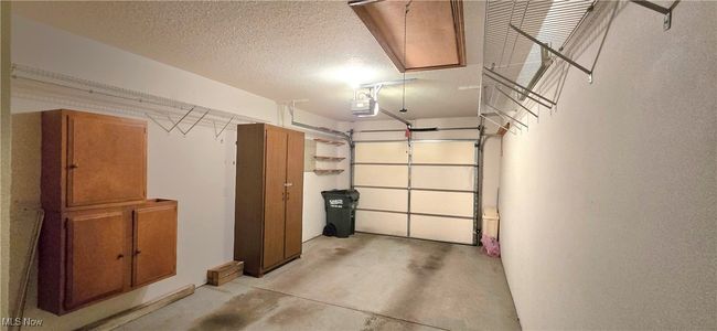 Garage with a garage door opener | Image 25