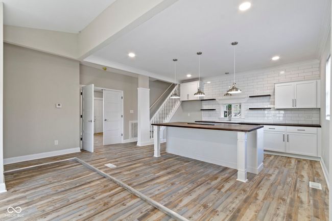 kitchen with white cabinetry, tasteful backsplash, open shelves, light wood-style flooring, and recessed lighting | Image 11
