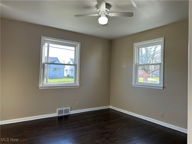 Master Bedroom with a ceiling fan, dark wood flooring. | Image 18