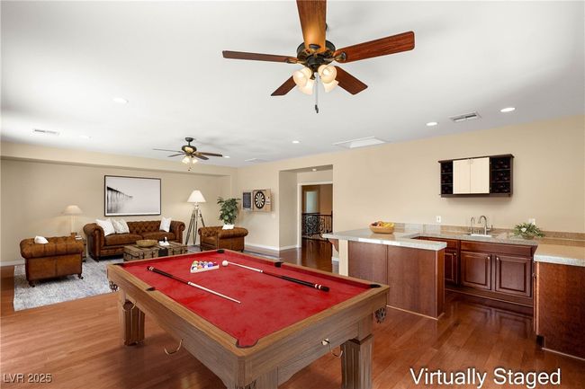 Game room featuring billiards, a sink, visible vents, wood finished floors, and a ceiling fan | Image 34