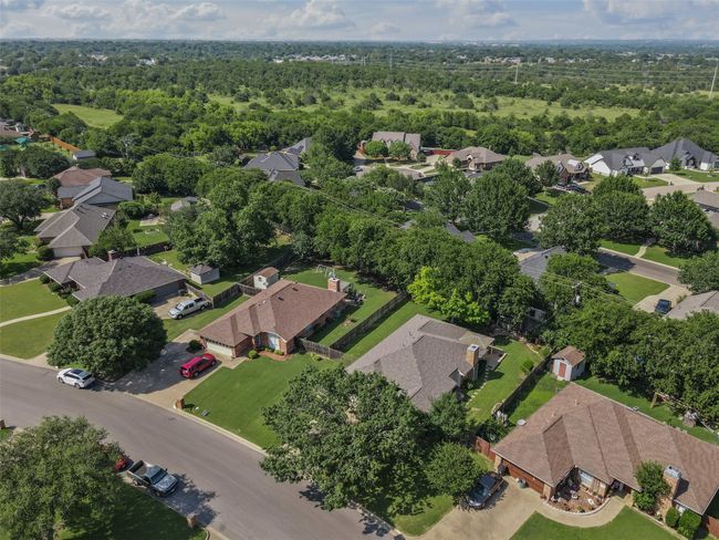 View of property location featuring nearby suburban area and a treed area. | Image 23