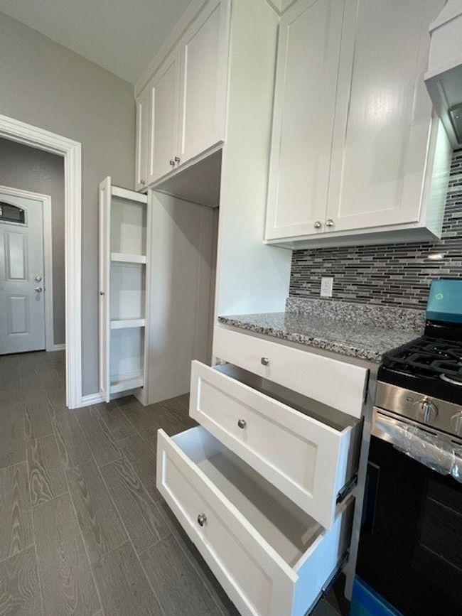 Kitchen features large pullout drawers for storage | Image 12