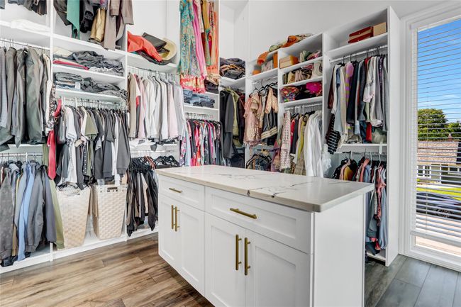 Spacious closet featuring light wood finished floors | Image 19