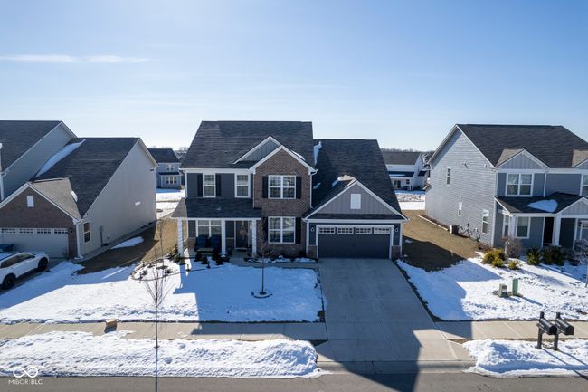 view of front facade featuring driveway, a garage, and board and batten siding | Image 4
