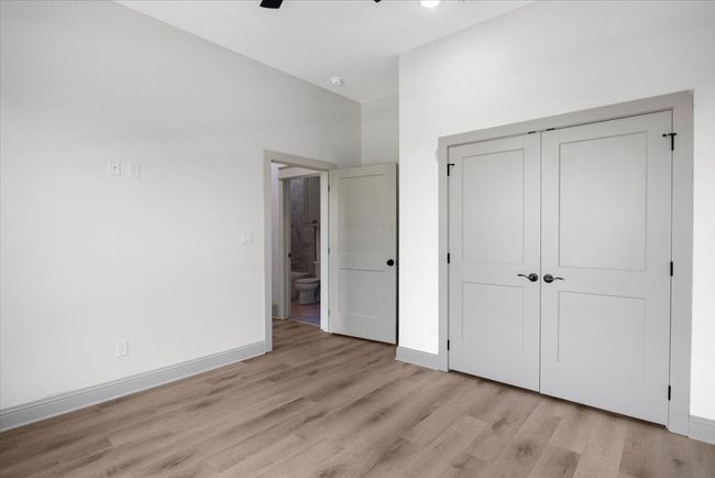 Unfurnished bedroom featuring light wood-style floors, a closet, and a ceiling fan | Image 38