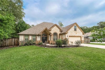 Charming 1.5-story residence nestled in a serene neighborhood, featuring an elegant brick/stone facade, lush landscaping, and a welcoming entrance - your perfect suburban retreat at 17006 N Saba. | Image 2