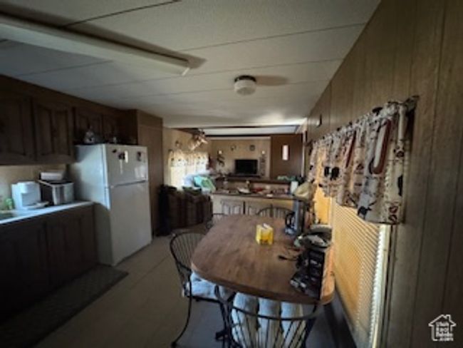 Dining area featuring wooden walls | Image 5