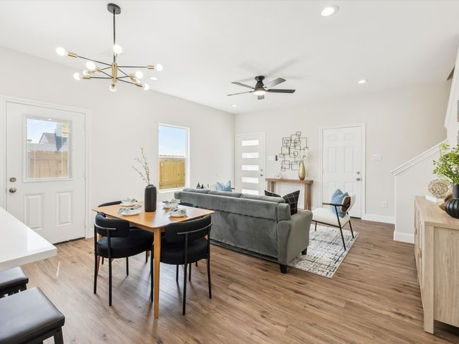 Dining room with baseboards, ceiling fan with notable chandelier, light wood finished floors, and recessed lighting | Image 12