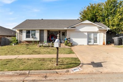 Ranch-style house featuring cooling unit and a front yard | Image 1