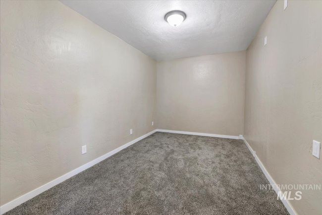 Unfurnished room with carpet flooring, a textured wall, and a textured ceiling | Image 7