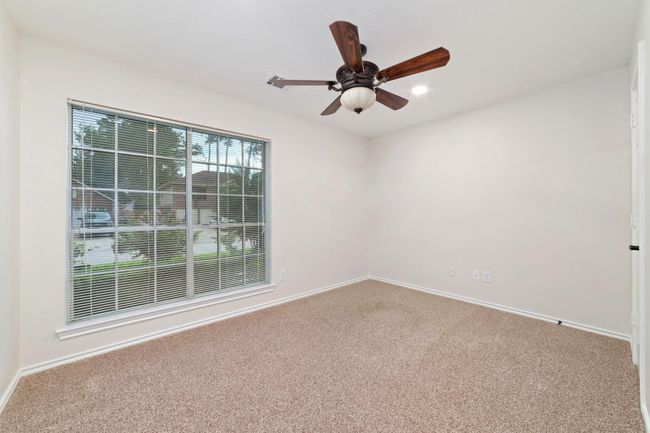 This spacious secondary room is enhanced by a large window that floods the space with natural light, creating a bright and inviting atmosphere. Thoughtfully designed for convenience, it is ideally situated near the secondary bathroom, ensuring easy access and added comfort for residents or guests. | Image 25