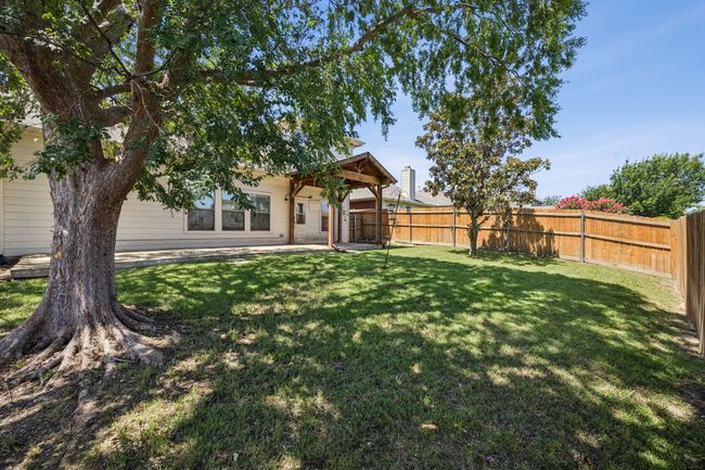 Fenced backyard with a Full length patio area | Image 24