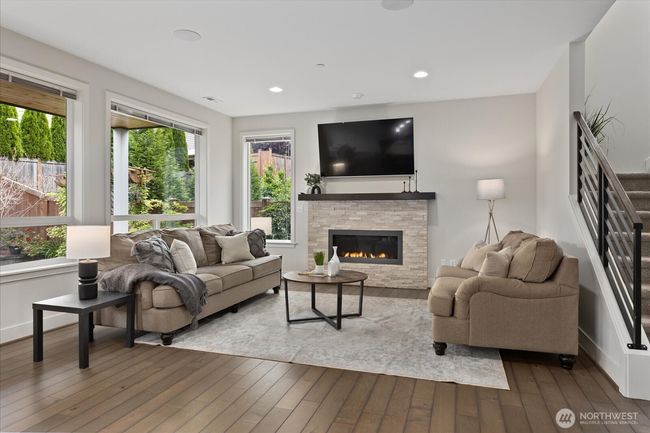Enjoy cozy evenings by the gas fireplace with large picture windows allowing lots of natural light | Image 5