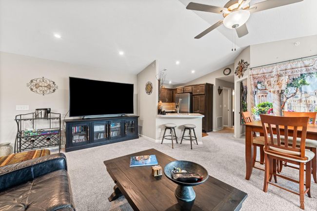 Large floor plan with vaulted ceilings, ceiling fan, large dining area. | Image 10
