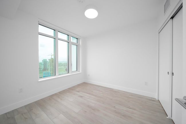 Unfurnished bedroom with light wood finished floors, baseboards, visible vents, and a closet | Image 8