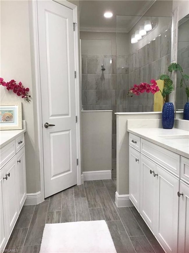 Primary bath with walk-in shower and dual vanities | Image 12