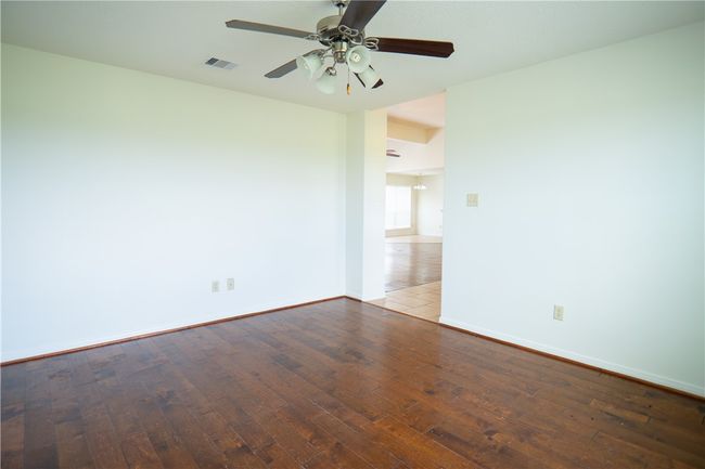 Empty room with wood-type flooring and ceiling fan | Image 20