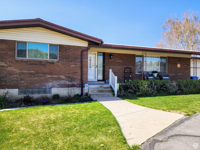 View of front of property with brick siding and a front lawn | Image 59