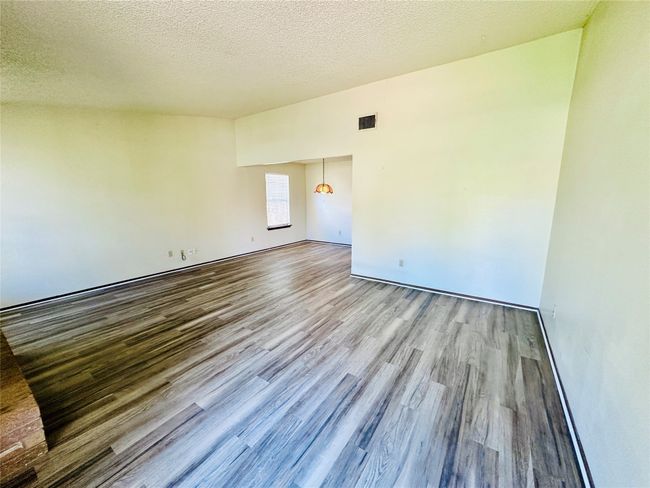 Unfurnished room with a textured ceiling and wood finished floors | Image 5