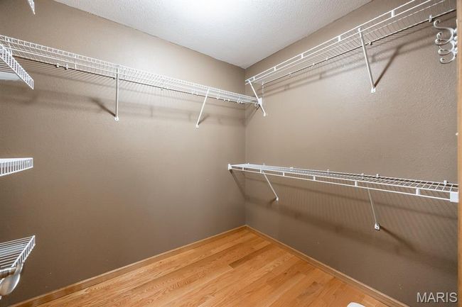 Spacious closet with wood finished floors | Image 25