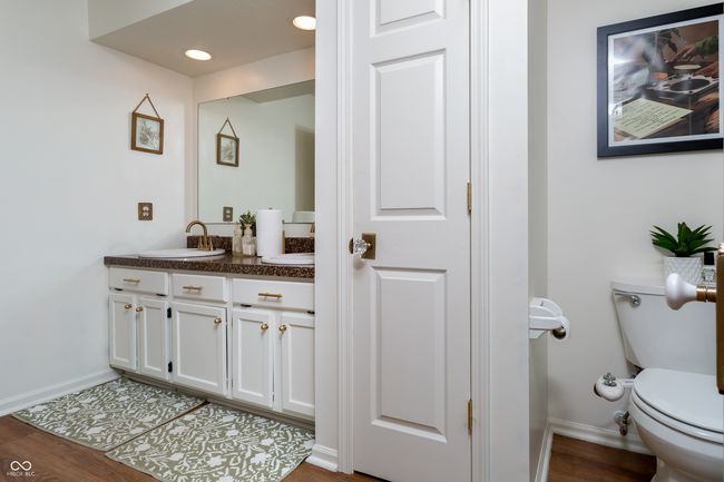 bathroom featuring vanity, wood finished floors, and recessed lighting | Image 21