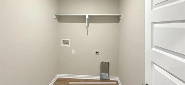 Washroom featuring washer hookup, electric dryer hookup, baseboards, wood finished floors, and laundry area | Image 10