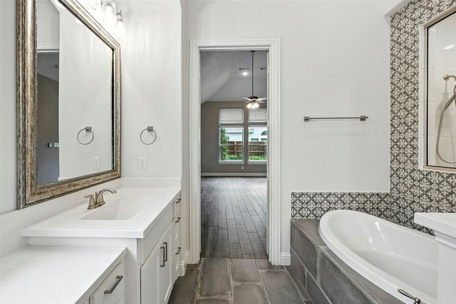 Bathroom with a garden tub, vanity, a ceiling fan, and wood finished floors | Image 23