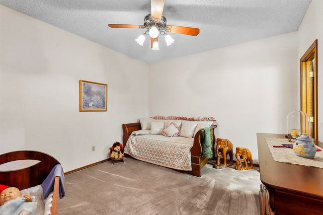 Carpeted bedroom featuring a textured ceiling and ceiling fan | Image 23