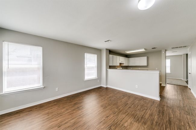 Unfurnished living room featuring dark hardwood / wood-style floors | Image 11