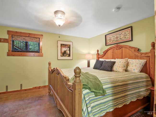Bedroom featuring concrete floors and a ceiling fan | Image 32