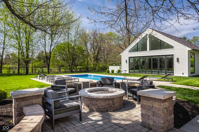 view of patio featuring fence, a fire pit, and a fenced in pool | Image 57
