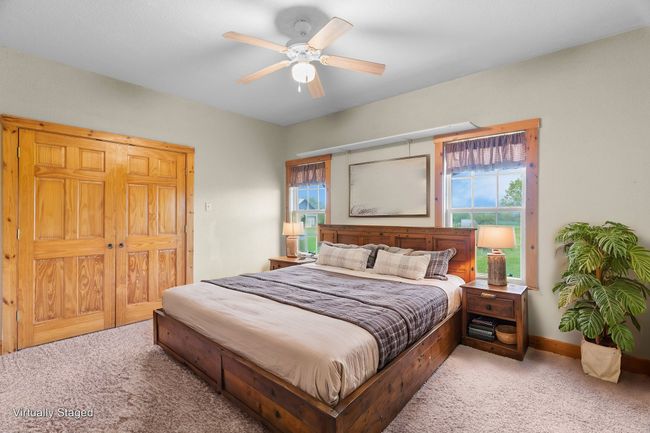 Bedroom featuring carpet flooring, baseboards, and ceiling fan | Image 26
