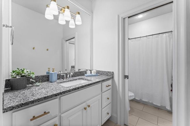 Full bath, sleek counters and modern lighting | Image 29