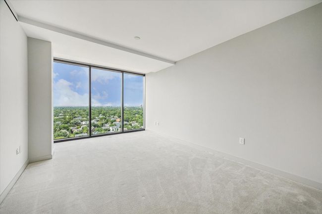 One of two secondary bedrooms that are north facing to enjoy views of the treetops of the River Oaks neighborhood. | Image 21